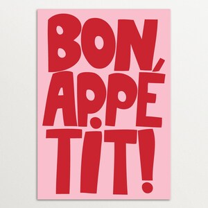 "Bon Appétit" wall art featuring oversized red block letters on a pink background, styled with playful typography and vibrant color contrast, ideal for modern kitchens, cafés, or bold interior accents.