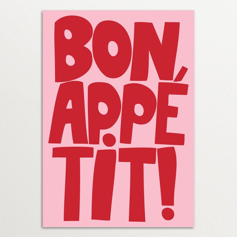 "Bon Appétit" wall art featuring oversized red block letters on a pink background, styled with playful typography and vibrant color contrast, ideal for modern kitchens, cafés, or bold interior accents.