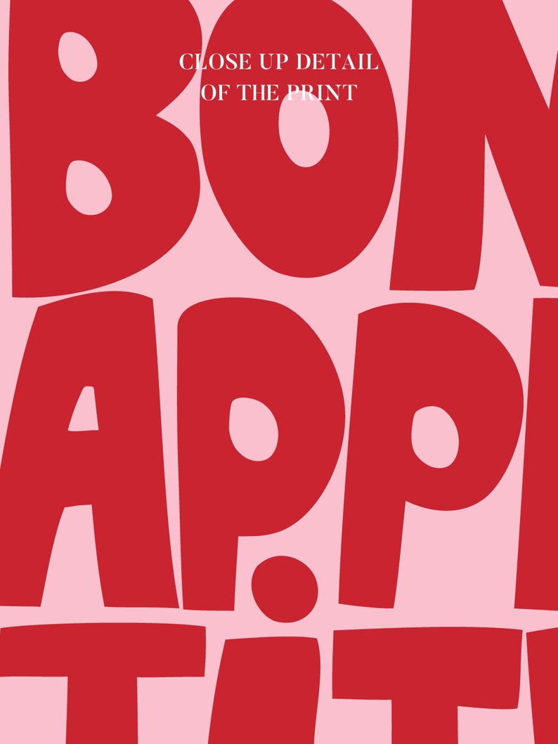 Detailed view of the "Bon Appétit" text in vibrant red chunky lettering on pastel pink, emphasizing the smooth matte finish and high-contrast color palette designed to energize contemporary kitchens or dining rooms.