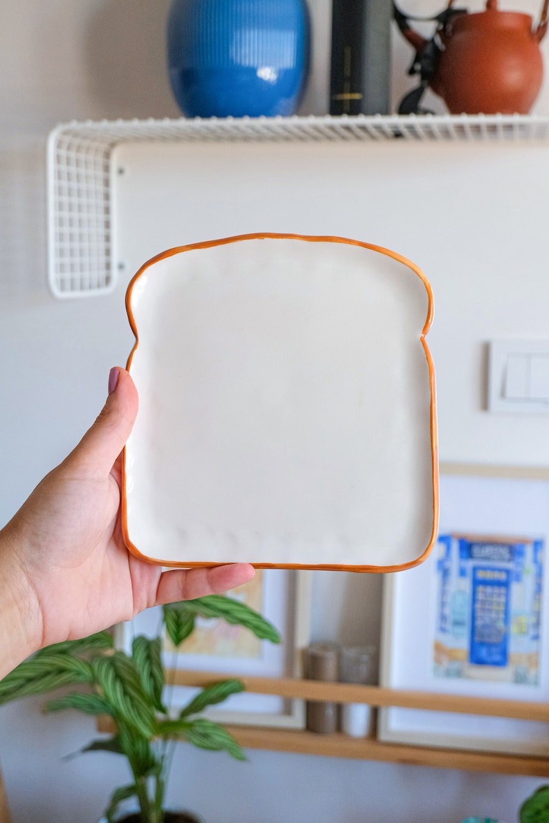 Toast Plate, handmade ceramic plate in toast shape. This plate looks like toast bread slice. Edges are slightly curved to upward. It is part of the bakery collection. Check our shop for more bakery collection items.