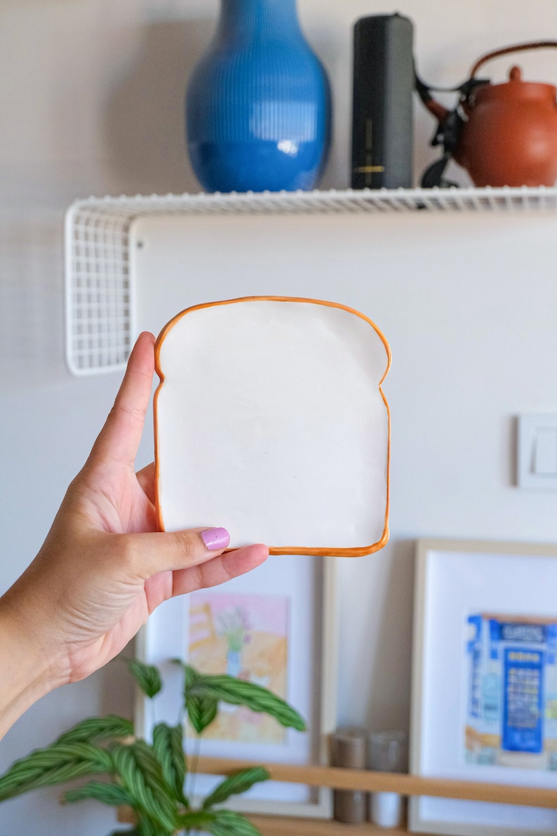 Mini Toast Plate. This is the small version of toast plate. It is exactly the same design but smaller. This plate looks like toast bread slice. Edges are slightly curved upward. This plate is part of the Bakery Collection.