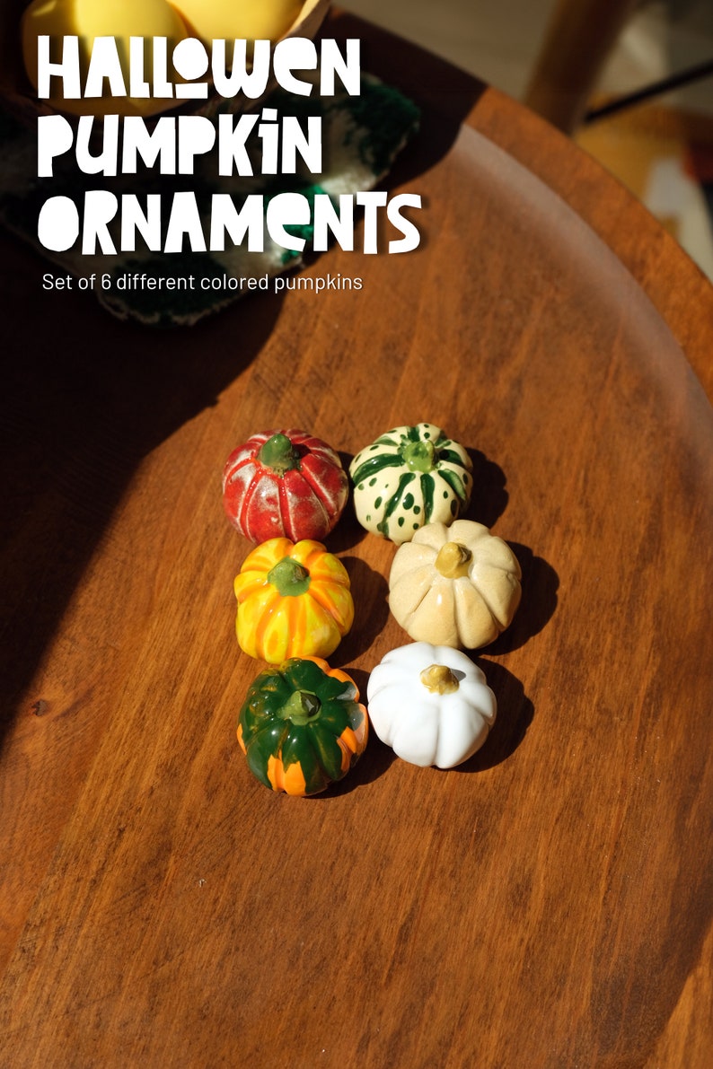 May include: Set of six Halloween pumpkin ornaments in various colors, including red, green, white, yellow, and orange. The pumpkins are on a wooden surface. "Halloween Pumpkin Ornaments" and "Set of 6 different colored pumpkins" are written in white text on the image.