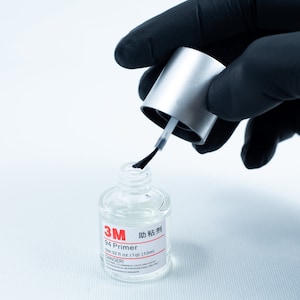 May include: A clear bottle of 3M 94 Primer adhesive with a silver cap and a black applicator brush. The bottle is labeled with the text "3M 94 Primer" and "Net 3.7 fl oz (110 ml)".