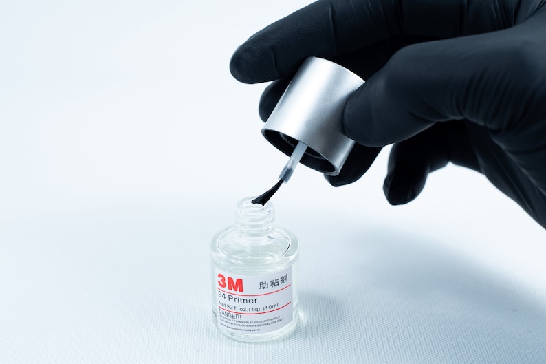 May include: A clear bottle of 3M 94 Primer adhesive with a silver cap and a black applicator brush. The bottle is labeled with the text "3M 94 Primer" and "Net 3.7 fl oz (110 ml)".