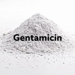 May include: A pile of white powder labelled "Gentamicin".