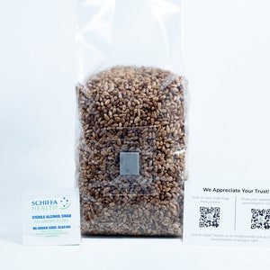 May include: A transparent plastic bag filled with brown grains, sealed with a metal square. Includes a sterile alcohol swab packet and a card with QR codes and the text "We Appreciate Your Trust!"