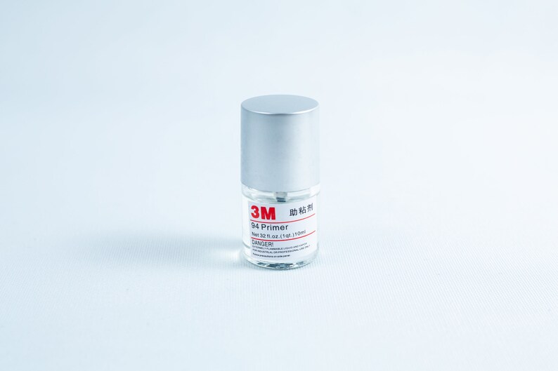 May include: A small silver bottle of 3M 94 Primer, with a red label that says "3M 94 Primer" and "Net 32 fl oz (1 qt) 1 L (1104 ml)". The label also has a red "DANGER!" warning.