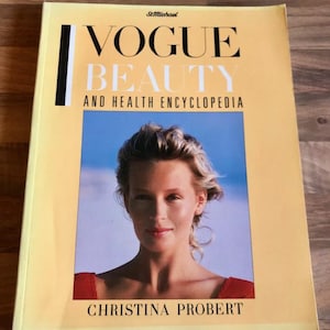 May include: A vintage book titled "Vogue Beauty and Health Encyclopedia" by Christina Probert. The cover features a woman's portrait against a blue background. The book has a yellow cover with black and white text.