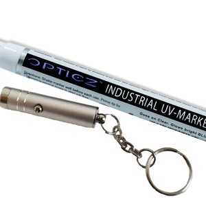 May include: A white industrial UV marker with a black label reading OPTICZ INDUSTRIAL UV-MARKER and a silver metal keychain flashlight. The marker includes instructions to shake well and notes that the ink goes on clear and glows bright blue.