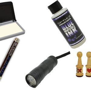 May include: A collection of spy-themed items, including a blacklight flashlight, a bottle of blue invisible ink, a pen with invisible ink, an ink pad, and two wooden stamps with red designs.