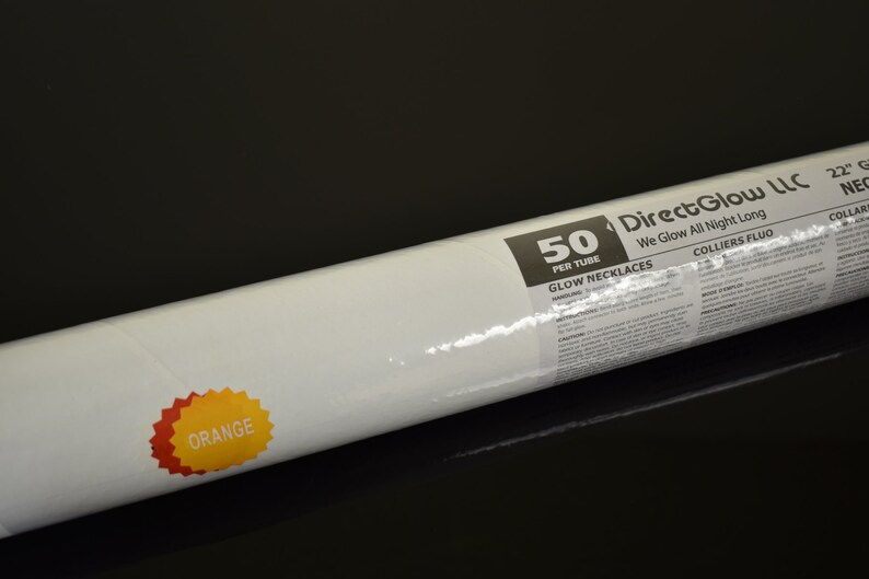 May include: A cylindrical tube containing 50 orange glow necklaces, measuring 22 inches each. The white label features the text DirectGlow LLC, We Glow All Night Long, 50 PER TUBE, GLOW NECKLACES, and a starburst graphic labeled ORANGE.