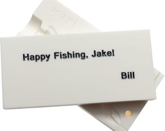 May include: A white rectangular object with the text "Happy Fishing, Jake!" and the name "Bill" in black. The object is partially covering a white, irregularly shaped base. The top object has the text "R1 3.5" in the upper left corner.