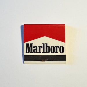 May include: A red and white matchbook with the word "Marlboro" printed in black letters.