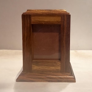 May include: A wooden picture frame with a dark brown finish. The frame has a single opening for a picture.