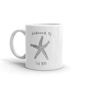 May include: White ceramic mug with a black and white illustration of a starfish and the text "Wildwood, NJ Est 1895".