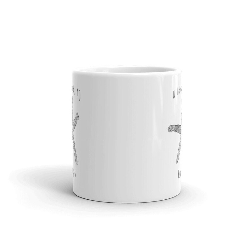 May include: White ceramic mug with a black and white illustration of a starfish and the text "Wildwood, NJ" on one side and "Wildwood, NJ" on the other side.