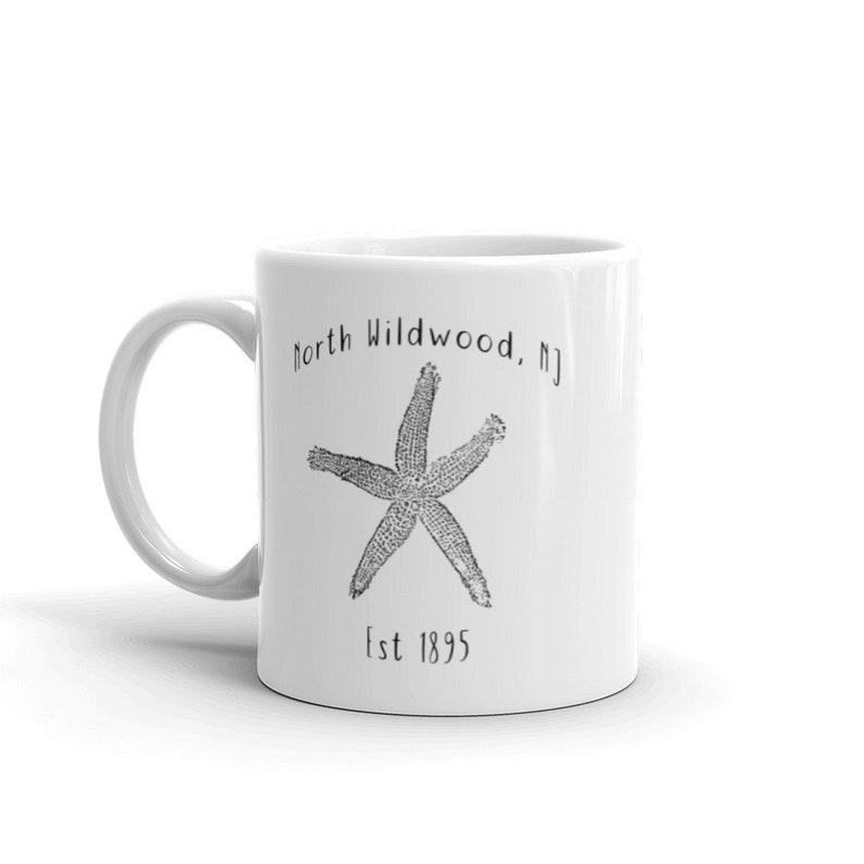 May include: White ceramic mug with a black and white illustration of a starfish and the text "North Wildwood, NJ Est 1895"