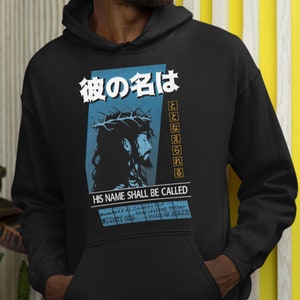 May include: Black hoodie with a graphic of Jesus Christ with a crown of thorns. The graphic includes Japanese text that says "His name shall be called" and English text that says "Wonderful Counselor, Everlasting Father, Mighty God, Prince of Peace."