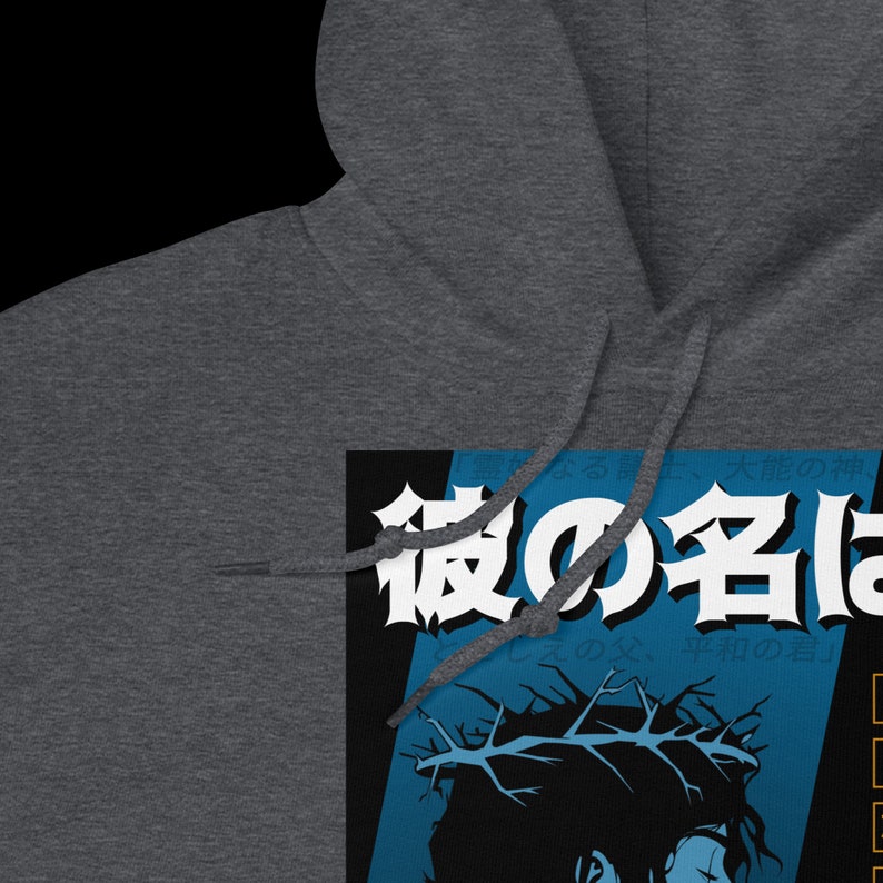 May include: A dark gray hooded sweatshirt with a graphic print of a person with a crown of thorns and the Japanese text "夜の手は" on a blue and black background.