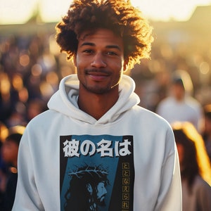 May include: A white hoodie with a graphic print of Jesus Christ with a crown of thorns. The graphic includes text in Japanese and English that reads "His name shall be called... Wonderful Counselor, Mighty God, Everlasting Father, Prince of Peace."