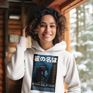 May include: White hoodie with a graphic print of a man with a crown of thorns. The graphic includes the text "His Name Shall Be Called" and Japanese text.