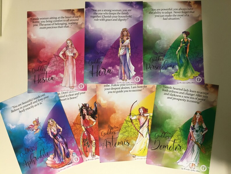 May include: A set of 8 colorful cards featuring illustrations of Greek goddesses. Each card has a different goddess with a quote about her attributes. The goddesses are Hestia, Hera, Persephone, Aphrodite, Artemis, Demeter, Athena, and Hecate.