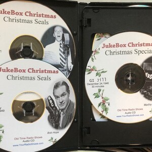 May include: A black DVD case containing several audio CDs. The CDs feature the text "JukeBox Christmas" and images of vintage radio personalities. The CDs are labeled "Christmas Seals" and "Christmas Special".