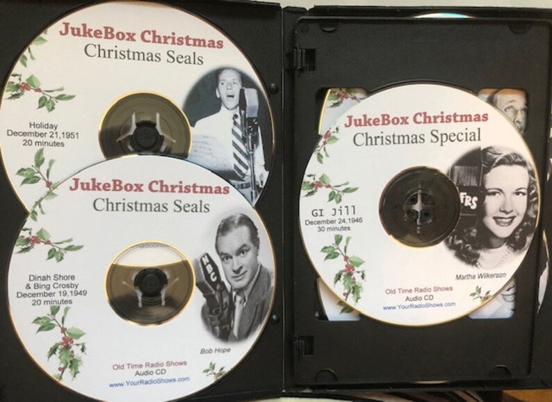 May include: A black DVD case containing several audio CDs. The CDs feature the text "JukeBox Christmas" and images of vintage radio personalities. The CDs are labeled "Christmas Seals" and "Christmas Special".