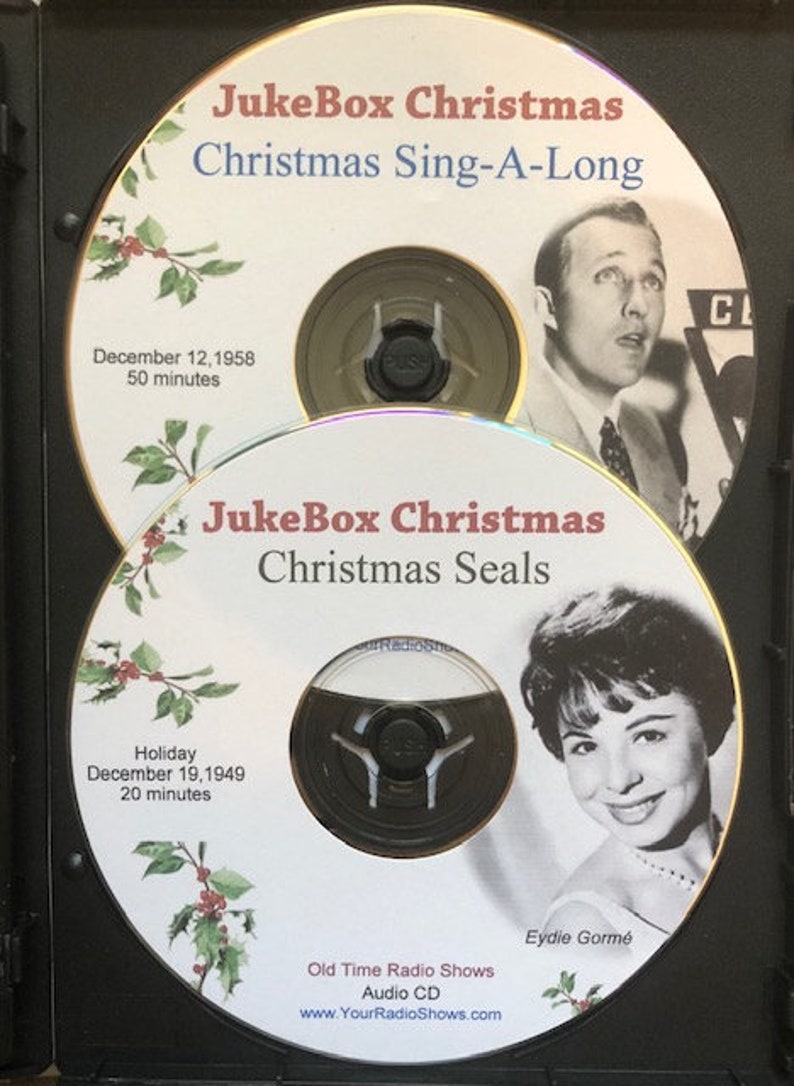 May include: Two vintage Christmas-themed CDs in a black case. The top CD is labeled "JukeBox Christmas Christmas Sing-A-Long" with a photo of a man. The bottom CD is "JukeBox Christmas Christmas Seals" with a photo of Eydie Gorm&eacute;.