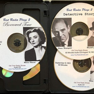 May include: A black CD case open to reveal four CDs. The CDs feature black and white images of actors and actresses. Text on the CDs reads "Best Radio Plays 2" and the titles of the plays. The CDs are labeled "Old Time Radio Shows Audio CD".