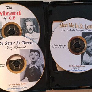 Pode incluir: Uma caixa preta contendo quatro CDs de &aacute;udio com Judy Garland. Os CDs incluem t&iacute;tulos como "O M&aacute;gico de Oz", "Nasce uma Estrela" e "Meet Me in St. Louis". Cada CD tem uma foto vintage de Judy Garland e a data da transmiss&atilde;o.