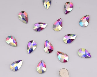May include: Assortment of iridescent teardrop-shaped rhinestones in various shades of pink and purple.