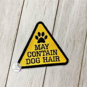 May include: Yellow triangle warning sign with a black paw print and the text "May Contain Dog Hair".
