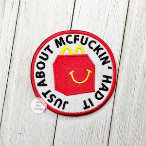 May include: Embroidered patch with a red and white design. The patch features a red box with yellow handles and a yellow smiling face. The text "JUST ABOUT MCFUCKIN' HAD IT" is in black around the box.