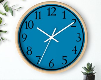 May include: A blue clock with black numbers and white hands. The clock has a wooden frame.
