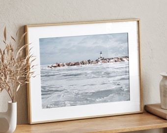 May include: A framed photograph of a lighthouse on a frozen lake with a wooden shelf and decorative vases.