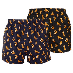 May include: Two pairs of boxer shorts with a fox print. One pair is navy blue with orange foxes, the other is black with orange foxes.