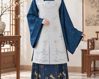 May include: A dark blue long-sleeved robe with a high collar and a light gray sleeveless vest featuring floral embroidery and button closures. The outfit includes a pleated dark blue skirt decorated with gold and blue bird and tree patterns.