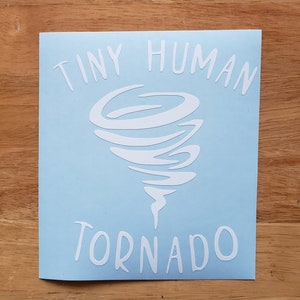 May include: A light blue sticker with a white tornado design and the text "Tiny Human Tornado".