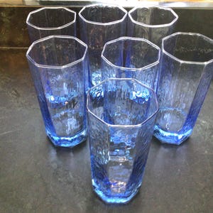 May include: A set of three ceramic mugs with a speckled, matte finish. The mugs are in shades of cream, light brown, and dark brown. Each mug has a simple, minimalist design, perfect for coffee or tea.