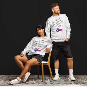 May include: Two white sweatshirts with a Puerto Rican flag design and the text "Aqui nadie quiso irse y quien se fue, sueña con volver".