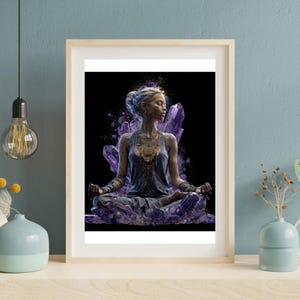 May include: A framed art print featuring a serene figure in a meditative pose, surrounded by and emerging from amethyst crystals. The artwork has a dark background and a light wooden frame. The figure is wearing a blue-gray dress and gold jewelry.