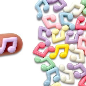 May include: Assortment of colorful plastic music note charms in various pastel colors, including pink, yellow, blue, green, and purple. The charms are shaped like musical notes and are perfect for adding a touch of whimsy to crafts and jewelry.