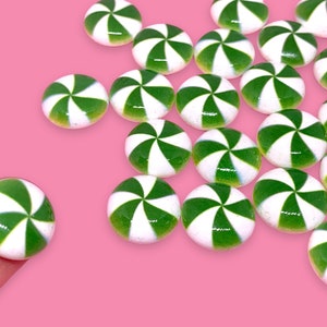 May include: A collection of green and white peppermint candy-shaped embellishments, perfect for crafting or decorating.