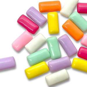 May include: Assortment of colorful rectangular plastic beads in various pastel shades, including pink, yellow, green, orange, and purple.