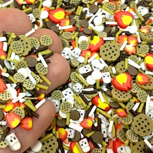 May include: A variety of colorful sprinkles in the shape of marshmallows, graham crackers, chocolate chips, and flames. The sprinkles are perfect for decorating cakes, cupcakes, and other desserts.