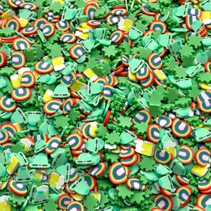 May include: A mix of green, yellow, red, and blue sprinkles in the shape of shamrocks, rainbows, beer mugs, and hats.