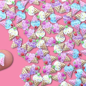 May include: A collection of colorful ice cream cone charms with pink, blue, and purple frosting and sprinkles. The charms are made of plastic and have a glossy finish.