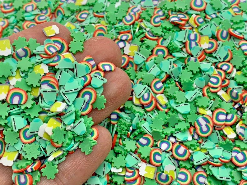 May include: A close-up of a variety of colorful sprinkles, including green shamrocks, rainbows, and beer mugs. The sprinkles are perfect for decorating cakes, cupcakes, and other treats.
