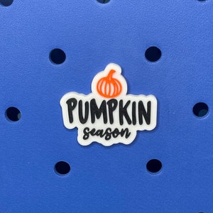 May include: A blue tote bag with a pumpkin-shaped sticker that says "Pumpkin season".